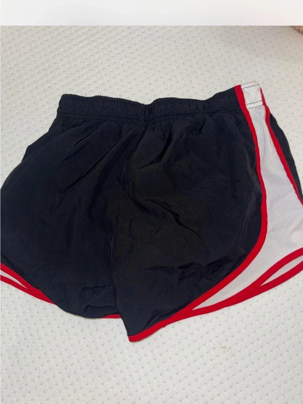 Nike Black Athletic Shorts with Red Trim and White Swoosh